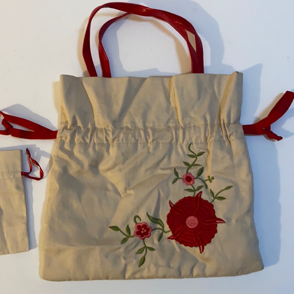 Avon beige and red embroidered drawstring bag